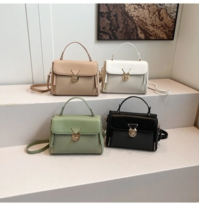 Detail of four casual crossbody bags in pink, white, green and black with metal clasps