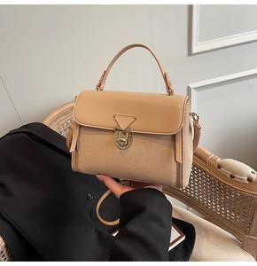 Detail of retro leather and canvas crossbody bag with gold triangular swivel lock