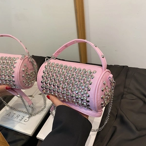 Pink rhinestone cylinder bag with metallic chain strap for shoulder and crossbody wear