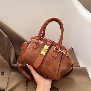 Brown crocodile embossed tote bag with gold turn-lock and versatile shoulder strap