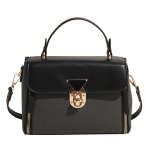 Gray textured knit handbag with black leather trim and triangle lock on white background