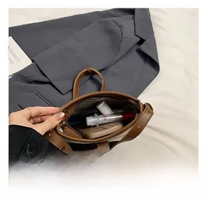 Internal capacity of brown leather bucket bag showing phone and cosmetics space