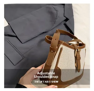 Detail of adjustable leather strap and canvas fabric on vintage crossbody saddle bag
