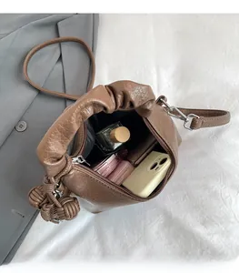 Internal view of brown bucket bag showing spacious storage for makeup and phone