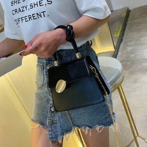 Black PU leather shoulder bag with a knotted handle and gold chain strap
