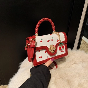Chic vintage cherry pattern handbag with woven red handle and golden floral clasp