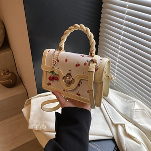 Fashionable cherry print handbag with yellow trim and woven handle for women