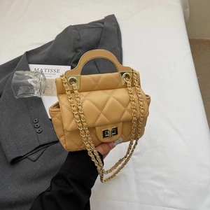 Quilted ginger yellow chain crossbody bag with a round gold handle and metal lock
