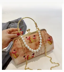 Detail of vintage crossbody bag with Tang dynasty art and pearl strap decoration