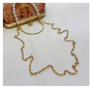 Detail of vintage shoulder bag with pearl handle, chain strap and oriental embroidery