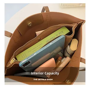 Top view of spacious brown leather tote bag interior with multiple compartments and zipper