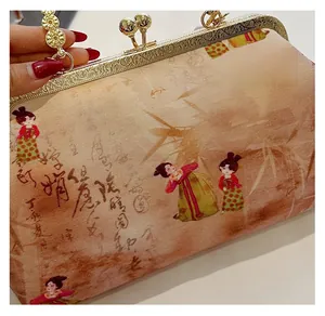 Detail of vintage evening bag with traditional Chinese embroidery and golden metal frame