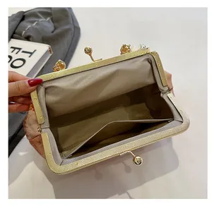 Internal view of retro clasp bag with golden metal frame and herringbone fabric lining