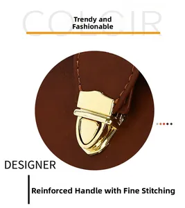 Detail of reinforced tote handle with golden buckle and precision stitching on brown leather