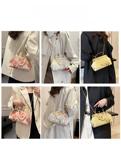 Detail view of retro embroidery handbag styles with pearl handles and metal chain straps