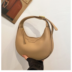 Close-up of khaki hobo bag with litchi texture leather and embossed KOASK logo details
