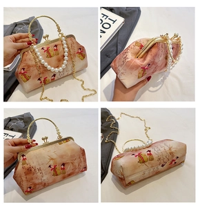Detail of vintage Chinese embroidery evening bag with pearl chain and clasp closure