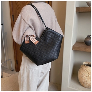Detail of black woven tote bag with V-cut opening and vintage plaid silk scarf decor