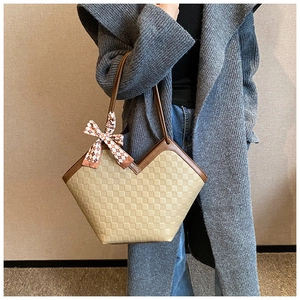 Detail of checkered embossed leather tote bag with silk scarf on a grey cardigan model