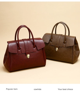 Close-up of premium cowhide leather handbags with elegant golden shield buckles