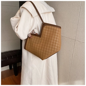 Detail of checkered tote bag with V-shaped opening and decorative floral silk scarf