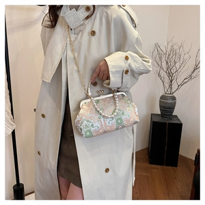 Detailed embroidery with classic cloud patterns and heart clasp on vintage evening bag