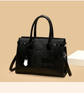 Detail of high-quality black embossed faux leather texture with metallic rivet accents