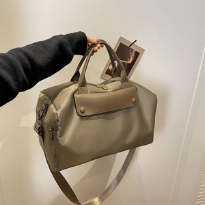 Minimalist large capacity travel bag in taupe with leather accents and shoulder strap