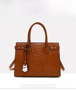 Front view of a brown crocodile embossed handbag with silver rivets and round top handles