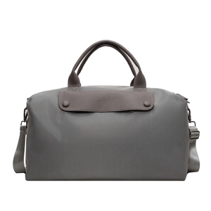 Large grey travel handbag with leather flap and detachable crossbody strap in studio light