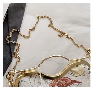 Macro detail of vintage floral embroidery and elegant gold metal frame with pearl charm