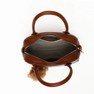 Top view of brown handbag showing gray herringbone lining and internal pocket