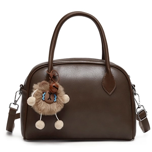 Minimalist dark brown crossbody handbag with lion plush charm and top handle