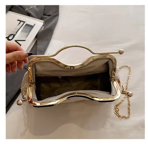 Detailed interior of the embroidered shell bag showing the inner pocket and gold clasp