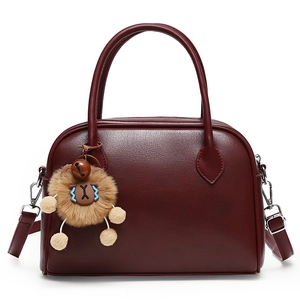 Minimalist deep red faux leather boston handbag with plush bear charm and crossbody strap