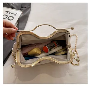 Internal view of the embroidered shell bag showing spacious storage for cosmetics
