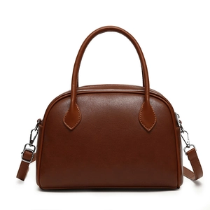 Detailed front view of brown PU leather boston bag with dual handles and silver hardware