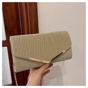 Detail view of gold sequin evening clutch featuring metallic V-shaped buckle and gold chain