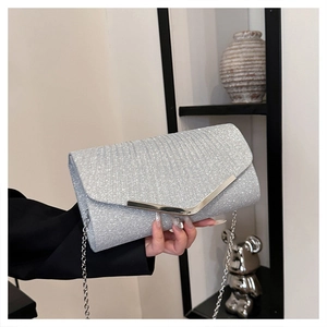 Detail of silver glitter envelope clutch featuring metallic V-trim and fine chain strap
