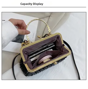 Internal view of black pleated shell bag showing capacity for phone and makeup