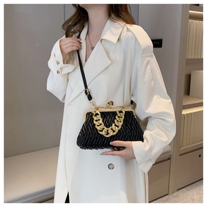 Détail du sac à main matelassé noir avec chaîne dorée et fermoir métallique chic