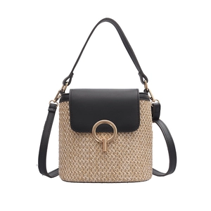 Sac seau en paille tressée avec bordure en cuir noir et fermoir en anneau doré élégant