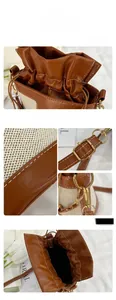 Detail view of brown leather and beige canvas bucket bag with drawstring closure