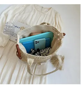 Top view of woven straw tote showing spacious interior with tablet and phone inside