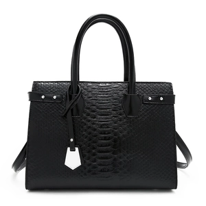 Classic black embossed leather handbag with top handles and silver hardware on white background