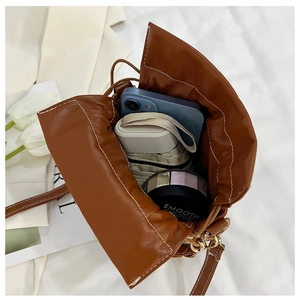 Top view of brown drawstring bucket bag interior showing large storage capacity