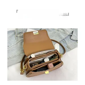 Vue intérieure du sac en cuir PU marron avec compartiments et fermoir doré carré