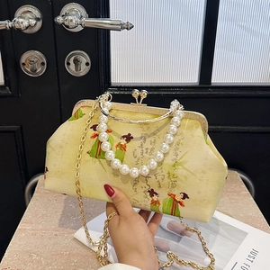 Retro shoulder bag with traditional embroidery, pearl handle, and gold metal clasp