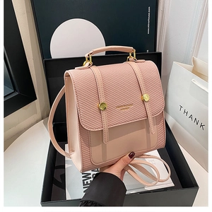 Gros plan du sac à dos rose en cuir PU avec texture tissée et boucles en métal doré