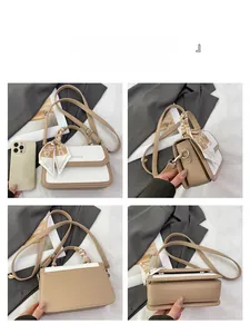 Detail view of contrast color crossbody bag with lychee texture and silk scarf handle